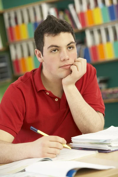Varón estresado estudiante adolescente que estudia en el aula — Foto de Stock