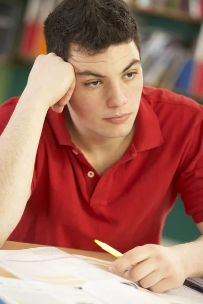 Benadrukt mannelijke tiener student studeert in klas — Stockfoto