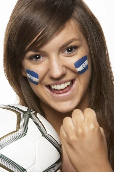 Jovem ventilador esportivo feminino com bandeira de Honduras pintada no rosto — Fotografia de Stock
