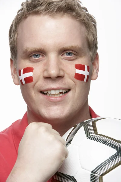 Junger männlicher Fußballfan mit dänischer Flagge im Gesicht — Stockfoto