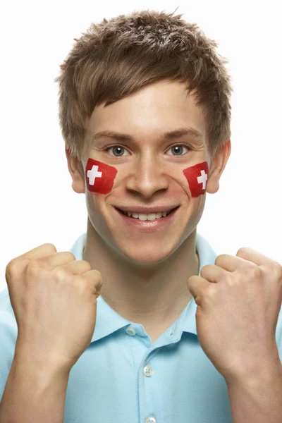 얼굴에 그려진 스위스 국기와 함께 젊은 남성 스포츠 팬 — 스톡 사진