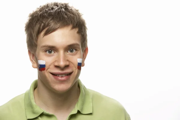 Fiatal férfi sport rajongó a Szlovák zászlót arcán festett — Stock Fotó