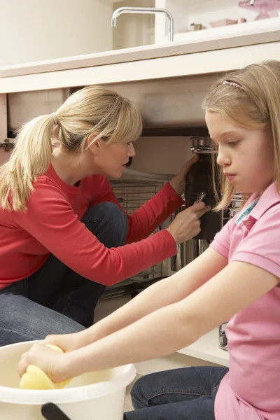 Daughter Helping Mother To Mop Up Leaking Sink — Stock Photo, Image