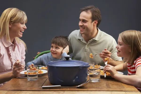 Familia disfrutando de la comida juntos en casa —  Fotos de Stock