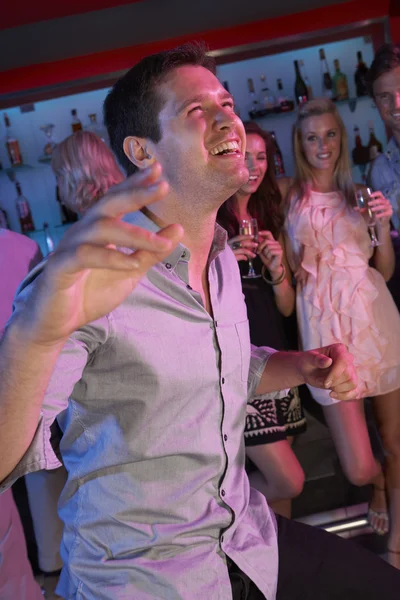 Young Man Having Fun In Busy Bar — Stock Photo, Image