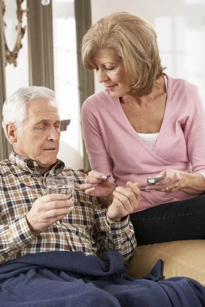 Senior Woman Caring For Sick Husband — Stock Photo, Image