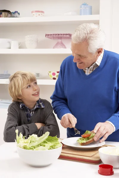 Farfar och sonson att göra smörgås i köket — Stockfoto