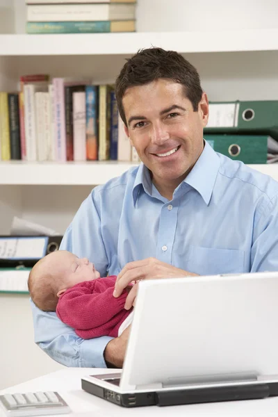 Father With Newborn Baby Working From Home Using Laptop — Stock Photo, Image