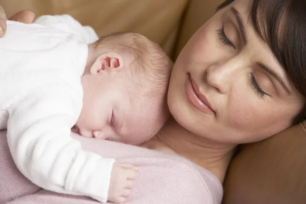 Retrato da mãe descansando com bebê recém-nascido em casa — Fotografia de Stock