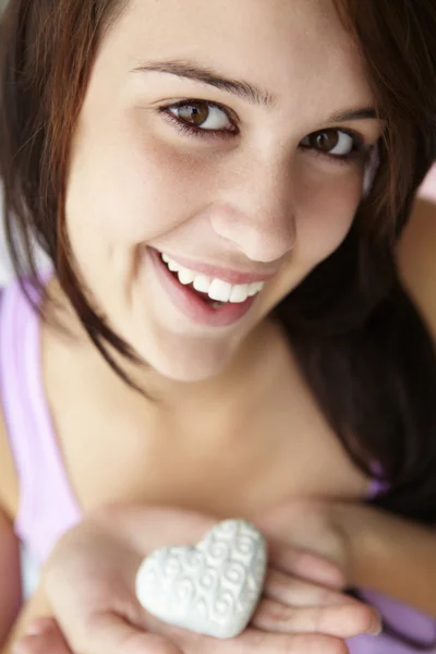 Teenage girl holding silver heart — Stock Photo, Image