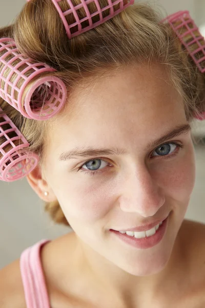 Teenage girl with hair in curlers — Stock Photo, Image