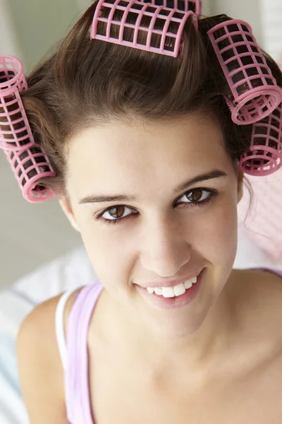Teenage girl with hair in curlers — Stock Photo, Image