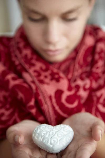 Teenage girl holding silver heart — Stock Photo, Image