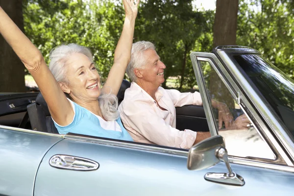 Coppia di anziani in auto sportive — Foto Stock