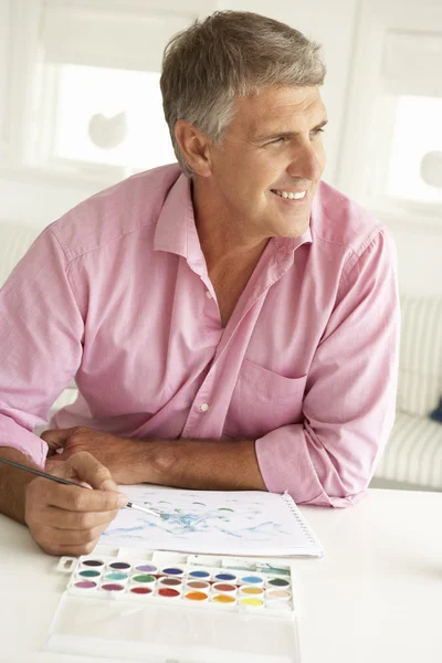 Mid age man painting with watercolors — Stock Photo, Image