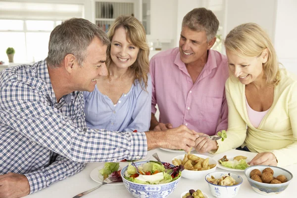 Midden leeftijd paren genieten van maaltijd thuis — Stockfoto