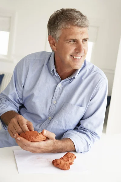 Mid age man clay modelling — Stock Photo, Image