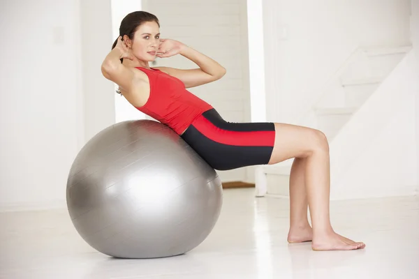Woman with gym ball in home gym — Stock Photo, Image