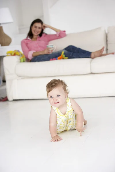 Moeder kijken baby crawl — Stockfoto