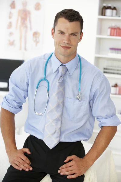 Young male doctor in consulting room — Stock Photo, Image