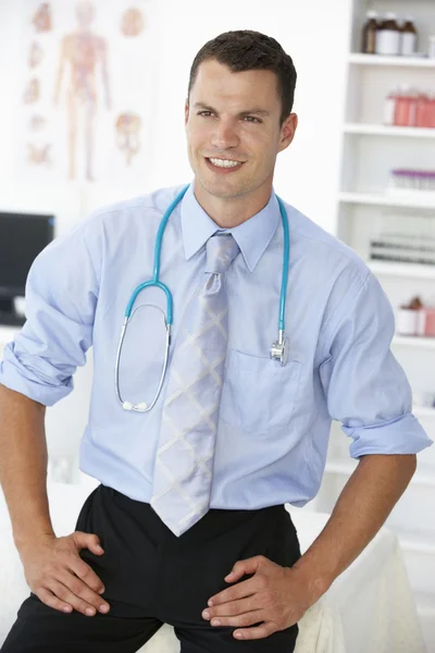 Young male doctor in consulting room — Stok fotoğraf