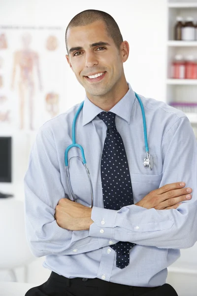 Young male doctor in consulting room — Stok fotoğraf