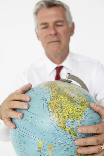 Senior businessman holding globe — Stock Photo, Image