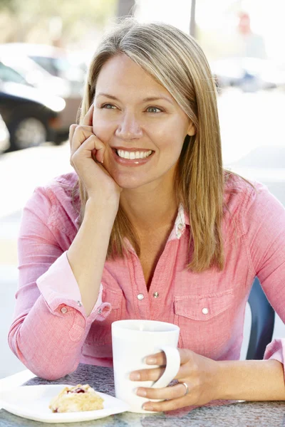 Femme assise au café sur le trottoir — Photo