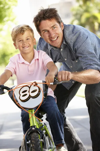 Father with boy on bike — Stock Photo, Image