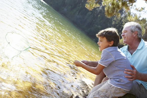 Man and boy fishing together — Stock Photo, Image
