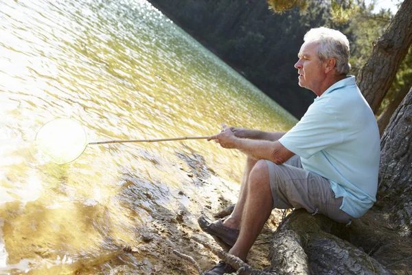 Senior mens vissen in het meer — Stockfoto