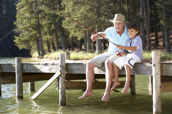 Senior man fishing with grandson — Stock Photo, Image