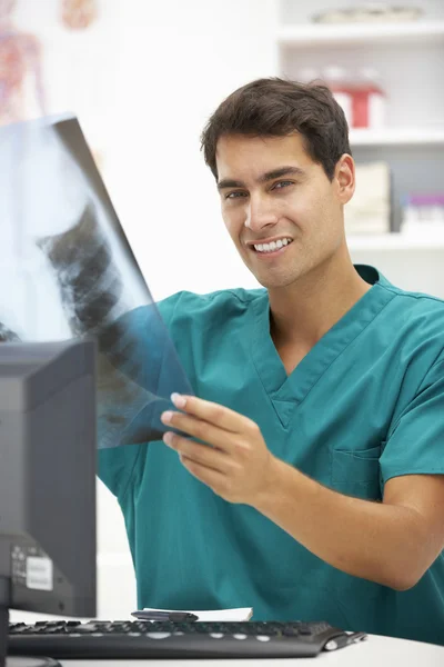 Young hospital doctor at desk — Stock Photo, Image