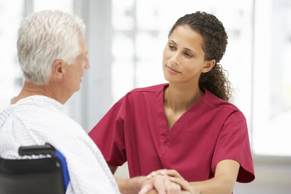 Senior patient with young doctor — Stock Photo, Image