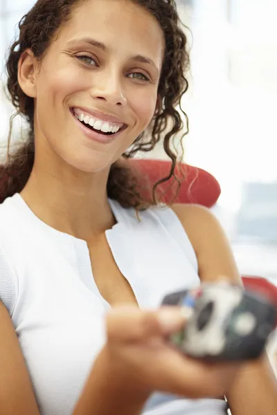 Young woman with remote control — Stock Photo, Image