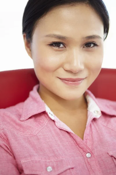 Young woman sitting in chair — Stock Photo, Image