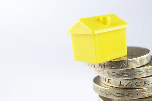 Small model house and coins — Stock Photo, Image