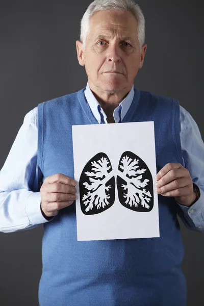 Senior man holding ink drawing of lungs — Stock Photo, Image