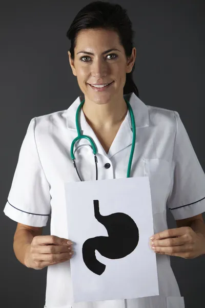 American nurse holding ink drawing of stomach — Stock Photo, Image