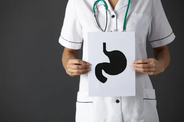 American nurse holding ink drawing stomach — Stock Photo, Image