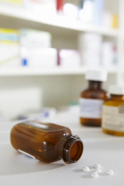 Prescription pill bottles on pharmacy shelf — Stock Photo, Image