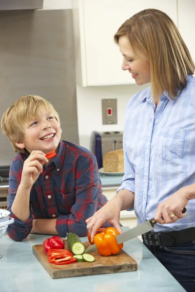 Mother and son preparing food in domestic kitchen — Stock Photo, Image