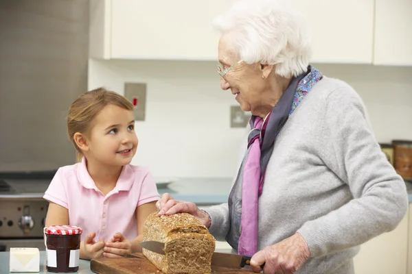 Бабушка и внучка готовят еду на кухне — стоковое фото