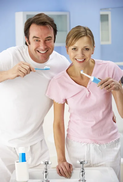Casal de limpeza de dentes juntos no banheiro — Fotografia de Stock