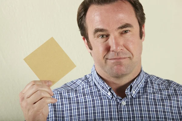 Studio Shot of Middle Aged Man Holding Wage Packet —  Fotos de Stock