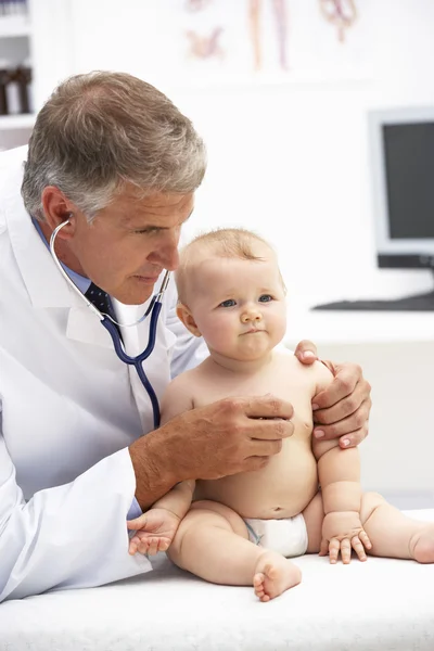 Pediatrician with baby Stock Image