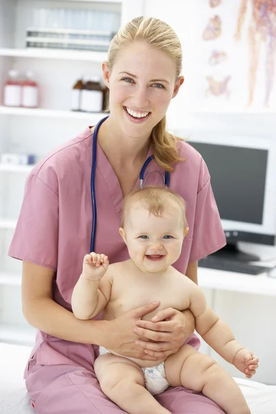 Pediatrician with baby Stock Image