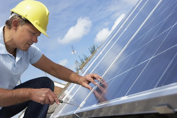 Man installing solar panels Royalty Free Stock Photos