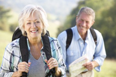Senior couple on country walk clipart
