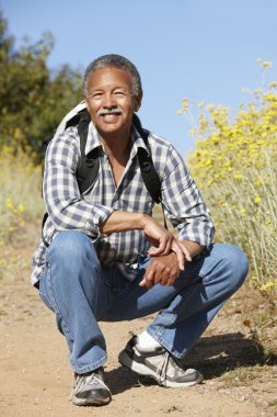 Senior man on country hike clipart